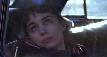 Movie still from “Carol” (2015), directed by Todd Haynes – A young woman sitting in the back seat of a car; Close Up shot, High angle