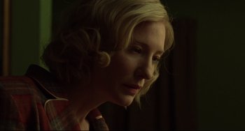 Movie still from “Carol” (2015), directed by Todd Haynes – A person with blonde curly hair; Close Up shot, Low angle
