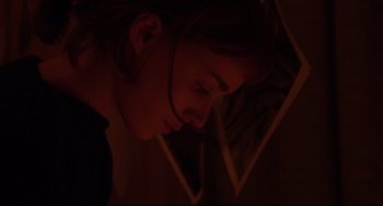 Movie still from “Carol” (2015), directed by Todd Haynes – A woman with her head down in a dark room; Close Up shot, Over the shoulder angle