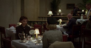 Movie still from “Carol” (2015), directed by Todd Haynes – A group of people sitting at a table in a restaurant; Medium shot, Over the shoulder angle
