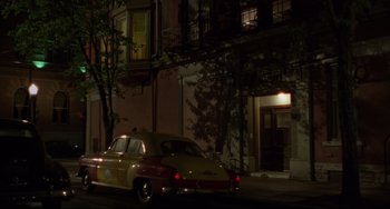 Movie still from “Carol” (2015), directed by Todd Haynes – An old car parked in front of a building at night; Extreme Wide shot, High angle