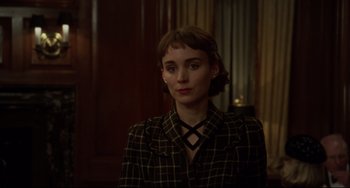 Movie still from “Carol” (2015), directed by Todd Haynes – A woman in a black and white checkered jacket; Close Up shot, Over the shoulder angle