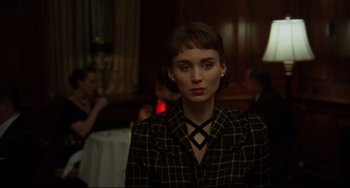 Movie still from “Carol” (2015), directed by Todd Haynes – A woman with short hair wearing a black and white checkered jacket; Close Up shot, High angle