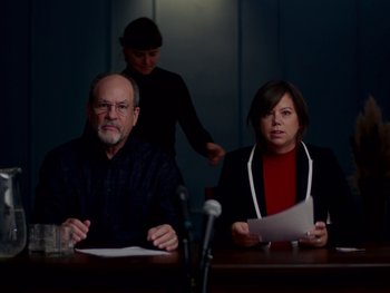 Movie still from “Casting JonBenet” (2017), directed by Kitty Green – A man and a woman sitting in front of a microphone; Medium shot, Over the shoulder angle