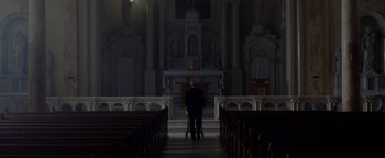 Movie still from “Casting JonBenet” (2017), directed by Kitty Green – A man standing in front of an altar in a church; Extreme Wide shot, Low angle