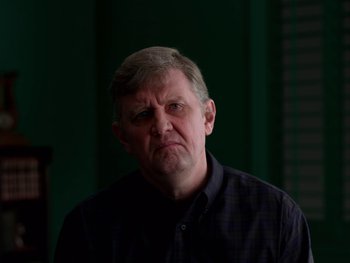Movie still from “Casting JonBenet” (2017), directed by Kitty Green – An older man with a frowning look on his face; Close Up shot, Low angle