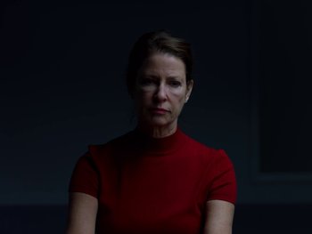 Movie still from “Casting JonBenet” (2017), directed by Kitty Green – A woman in a red shirt is looking at the camera; Close Up shot, Low angle