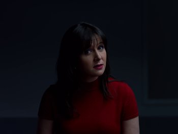 Movie still from “Casting JonBenet” (2017), directed by Kitty Green – A woman wearing a red shirt is looking up; Close Up shot, Low angle