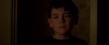 Movie still from “Casting JonBenet” (2017), directed by Kitty Green – A young boy is looking into the camera; Close Up shot, Low angle