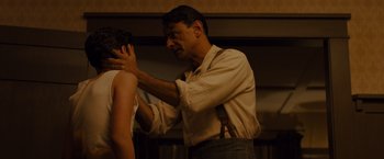 Movie still from “Unbroken” (2014), directed by Angelina Jolie – A man is touching a woman's breast; Medium shot, Over the shoulder angle