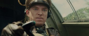 Movie still from “Unbroken” (2014), directed by Angelina Jolie – A person wearing a hat; Close Up shot, Low angle