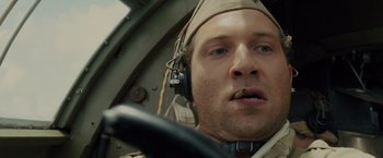 Movie still from “Unbroken” (2014), directed by Angelina Jolie – A person wearing headphones; Close Up shot, Low angle