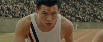 Movie still from “Unbroken” (2014), directed by Angelina Jolie – A man in a white tank top; Close Up shot, High angle