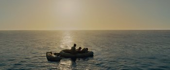 Movie still from “Unbroken” (2014), directed by Angelina Jolie – A couple of people on a raft in the middle of the ocean; Extreme Wide shot, High angle