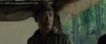 Movie still from “Unbroken” (2014), directed by Angelina Jolie – A man wearing a hat and a uniform; Close Up shot, Over the shoulder angle