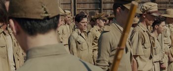 Movie still from “Unbroken” (2014), directed by Angelina Jolie – A group of men standing next to each other in uniform; Medium shot, High angle