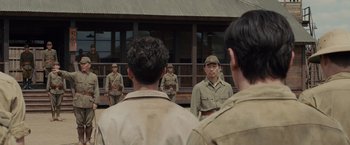 Movie still from “Unbroken” (2014), directed by Angelina Jolie – A group of men standing next to each other in uniform; Medium shot, Over the shoulder angle