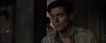 Movie still from “Unbroken” (2014), directed by Angelina Jolie – A person wearing a hat; Close Up shot, Over the shoulder angle