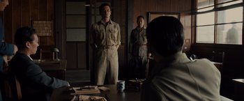 Movie still from “Unbroken” (2014), directed by Angelina Jolie – Two men standing next to each other in front of a mirror; Medium shot, Over the shoulder angle