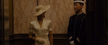 Movie still from “Unbroken” (2014), directed by Angelina Jolie – A man and a woman dressed up in formal wear; Medium shot, Low angle