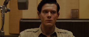 Movie still from “Unbroken” (2014), directed by Angelina Jolie – A person wearing a shirt; Close Up shot, Over the shoulder angle