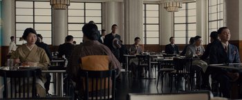 Movie still from “Unbroken” (2014), directed by Angelina Jolie – A group of people sitting at tables in a room; Wide shot, High angle