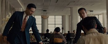 Movie still from “Unbroken” (2014), directed by Angelina Jolie – People sitting at tables in a large restaurant; Medium shot, Low angle