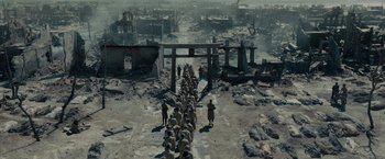 Movie still from “Unbroken” (2014), directed by Angelina Jolie – A group of people walking down a road in the middle of a city; Extreme Wide shot, High angle