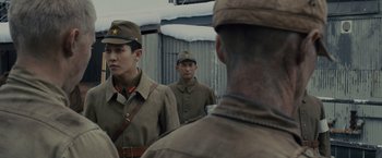 Movie still from “Unbroken” (2014), directed by Angelina Jolie – A group of men standing next to each other in uniform; Close Up shot, Over the shoulder angle