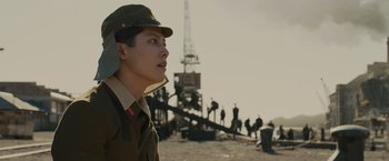 Movie still from “Unbroken” (2014), directed by Angelina Jolie – A man in a military uniform looking off into the distance; Close Up shot, Low angle