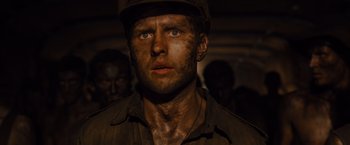 Movie still from “Unbroken” (2014), directed by Angelina Jolie – A person wearing a hat; Close Up shot, Low angle