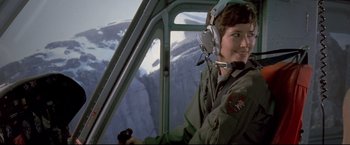 Movie still from “Cliffhanger” (1993), directed by Renny Harlin – A man in a helicopter flying over a snowy mountain; Medium shot, Low angle