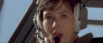 Movie still from “Cliffhanger” (1993), directed by Renny Harlin – A person talking on a cell phone; Close Up shot, Low angle