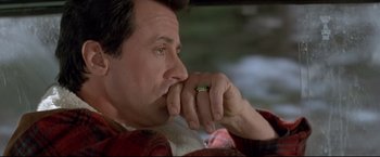 Movie still from “Cliffhanger” (1993), directed by Renny Harlin – A person with his hand on his chin; Close Up shot, High angle