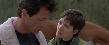 Movie still from “Cliffhanger” (1993), directed by Renny Harlin – A man and a woman looking at one another; Close Up shot, Over the shoulder angle
