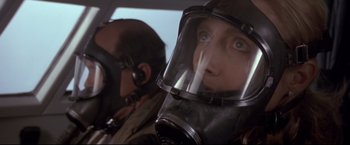 Movie still from “Cliffhanger” (1993), directed by Renny Harlin – A person wearing a gas mask in a vehicle; Close Up shot, Low angle