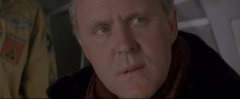 Movie still from “Cliffhanger” (1993), directed by Renny Harlin – An older man with blue eyes stares at the camera; Close Up shot, Low angle