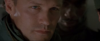 Movie still from “Cliffhanger” (1993), directed by Renny Harlin – A man's face in a dimly - lit room; Close Up shot, Low angle