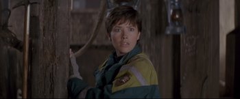 Movie still from “Cliffhanger” (1993), directed by Renny Harlin – A woman in a green and yellow jacket looking at the camera; Close Up shot, Low angle