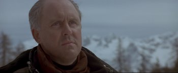 Movie still from “Cliffhanger” (1993), directed by Renny Harlin – A person wearing a scarf looking at the camera; Close Up shot, Low angle