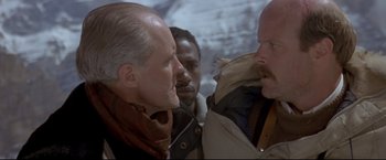 Movie still from “Cliffhanger” (1993), directed by Renny Harlin – A group of men standing next to each other; Close Up shot, Low angle
