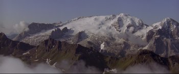 Movie still from “Cliffhanger” (1993), directed by Renny Harlin – A snowy mountainside with a church on top of it; Extreme Wide shot, High angle