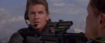 Movie still from “Cliffhanger” (1993), directed by Renny Harlin – A person with a rifle; Close Up shot, Low angle