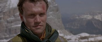 Movie still from “Cliffhanger” (1993), directed by Renny Harlin – A person on a mountain; Close Up shot, Low angle