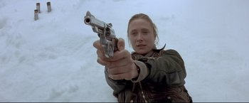 Movie still from “Cliffhanger” (1993), directed by Renny Harlin – A woman holding a gun in her hand; Close Up shot, Low angle