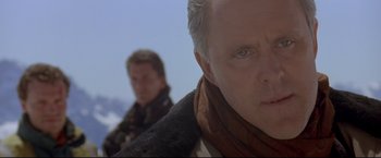 Movie still from “Cliffhanger” (1993), directed by Renny Harlin – A man in a scarf and a man in a jacket; Close Up shot, Low angle