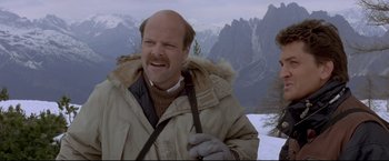 Movie still from “Cliffhanger” (1993), directed by Renny Harlin – A man with a beard and a jacket on; Close Up shot, Low angle