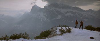 Movie still from “Cliffhanger” (1993), directed by Renny Harlin – A view of a mountain range with snow on the ground; Extreme Wide shot, Low angle