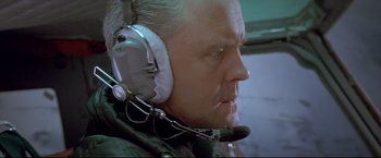 Movie still from “Cliffhanger” (1993), directed by Renny Harlin – An older man wearing a pair of headphones; Close Up shot, Low angle