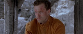 Movie still from “Cliffhanger” (1993), directed by Renny Harlin – A person wearing a yellow shirt; Close Up shot, Low angle